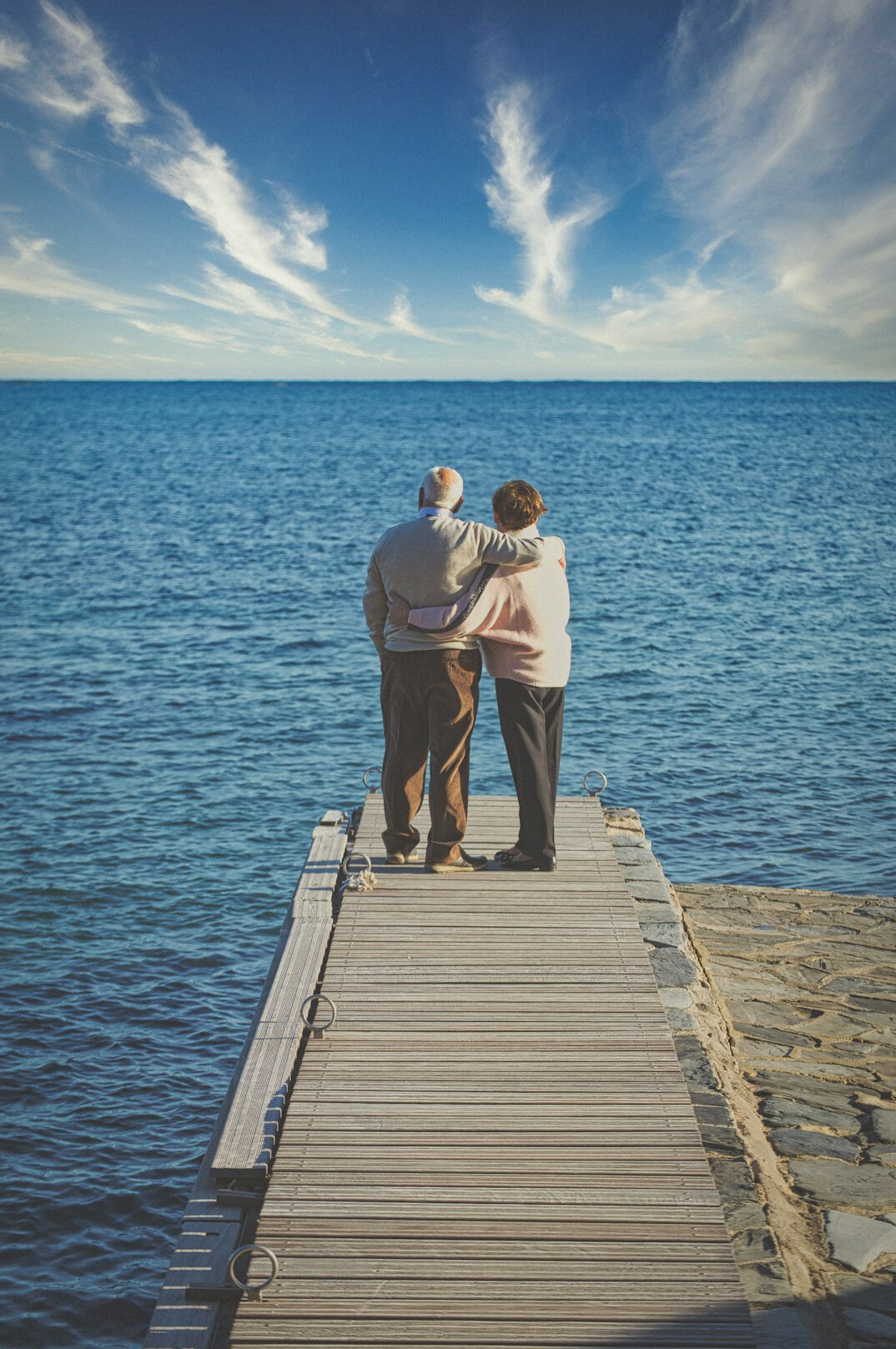 Senior Japanese couple reviewing retirement savings documents together at home