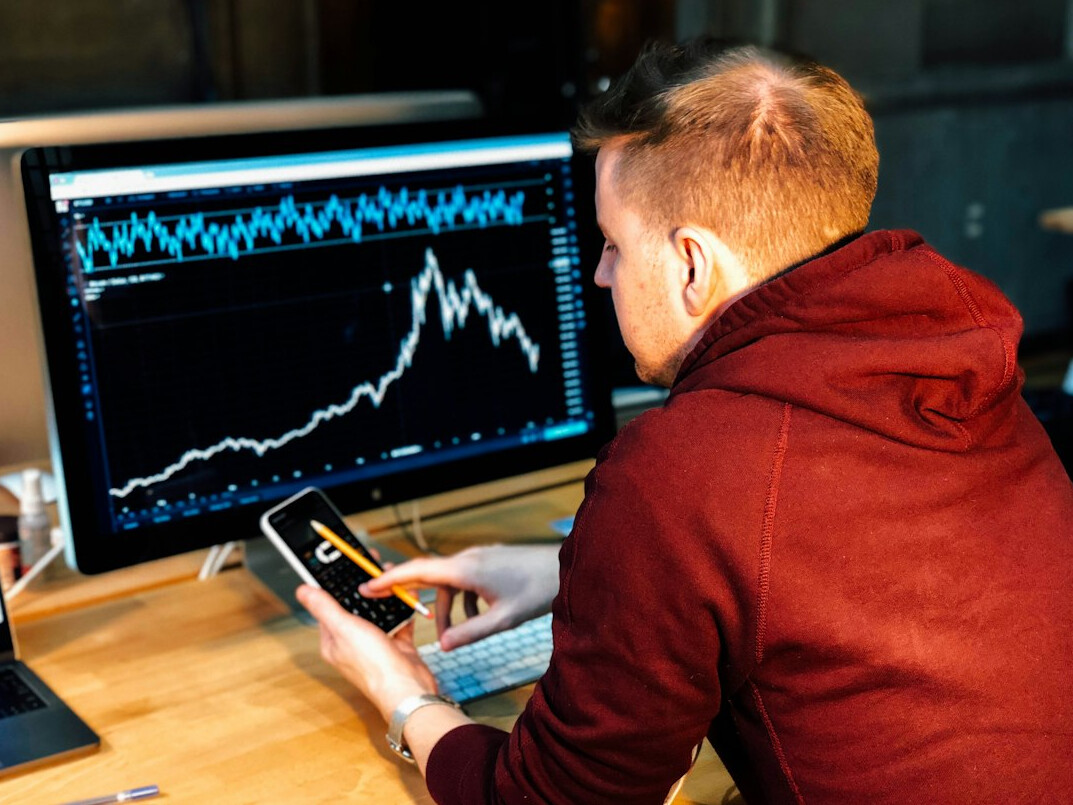 person analyzing financial charts